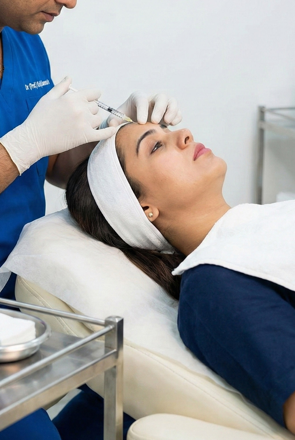 Vertical photo of a dermatologist administering a Botox injection on a patient's forehead at Dr (Prof.) Kshitij Saxena's Skin Clinic in Lucknow.